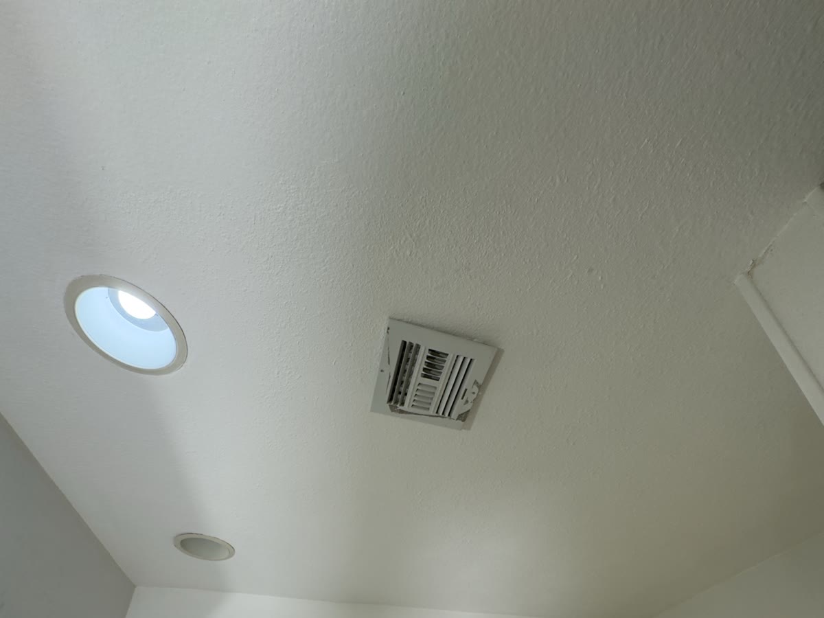 Completed ceiling repair with matched texture